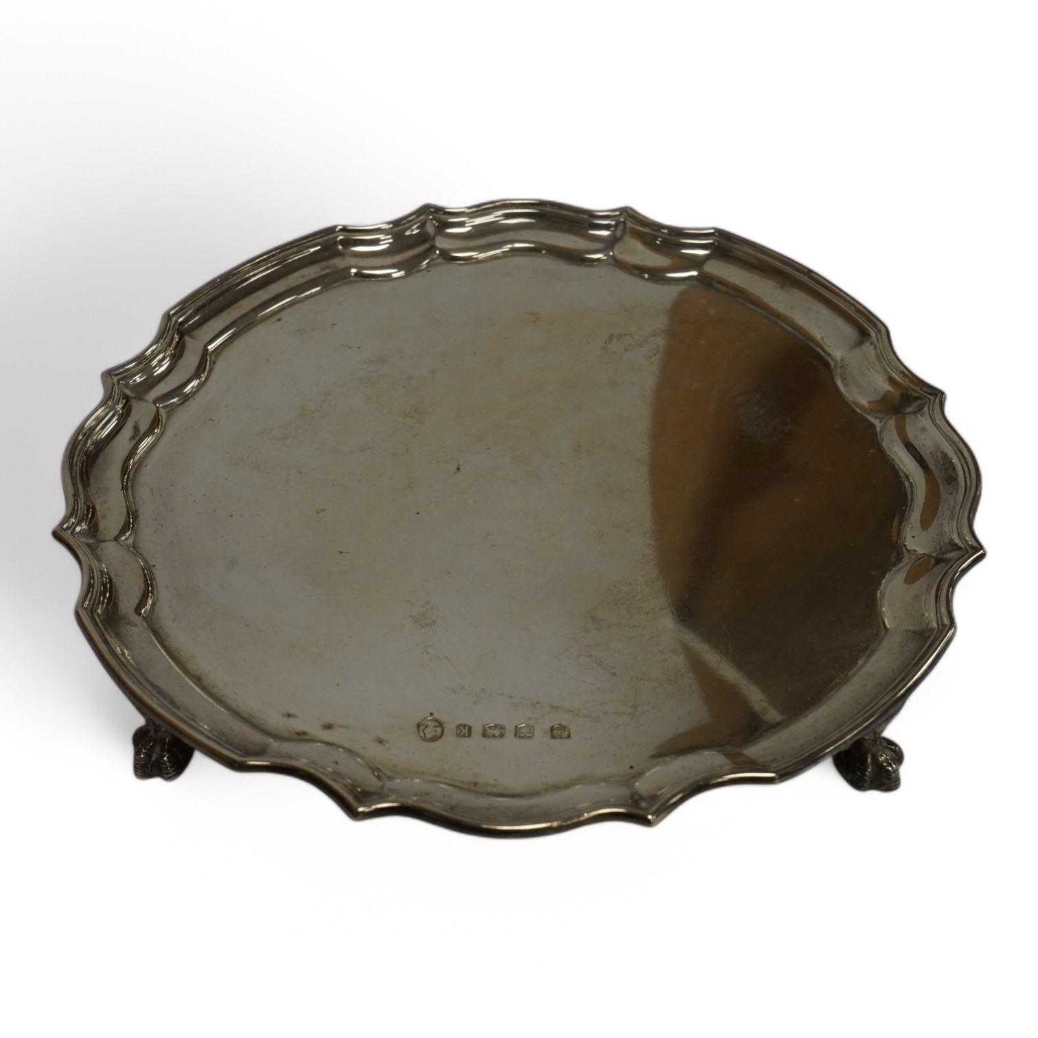 An Elizabeth II silver salver, by Poston Products Ltd, Sheffield, 1952, 25.4cm, with pie crust border, on four claw and ball feet, 17oz. Condition - fair to good